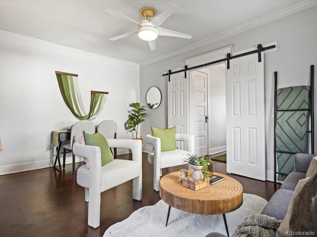 living room with ceiling fan, a barn door, dark hardwood / wood-style flooring, and ornamental molding