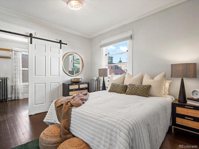 bedroom with crown molding, a barn door, and dark hardwood / wood-style floors