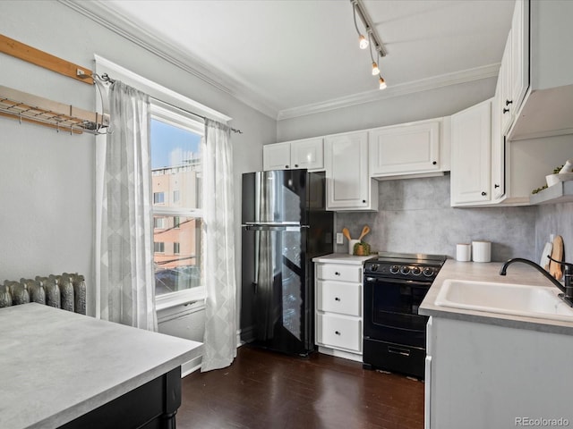 kitchen with sink, white cabinets, black appliances, and track lighting