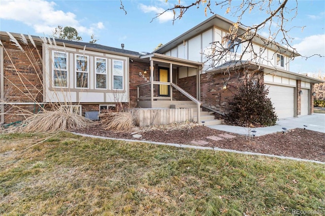 view of front of property featuring a garage and a front lawn