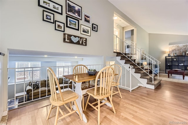 17404 E Prentice Cir, Centennial, CO 80015 - dining area featuring wood finished floors, stairway, and a towering ceiling