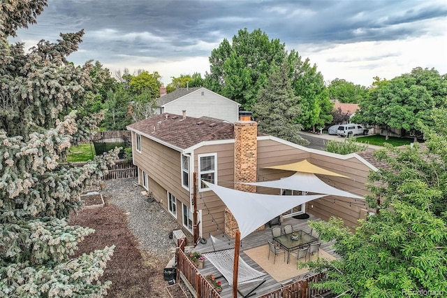 17404 E Prentice Cir, Centennial, CO 80015 - view of home's exterior with a chimney, outdoor dining space, and a wooden deck