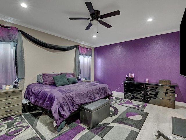 bedroom with crown molding, ceiling fan, and light hardwood / wood-style floors