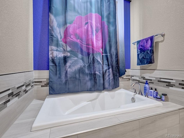 bathroom with tiled bath