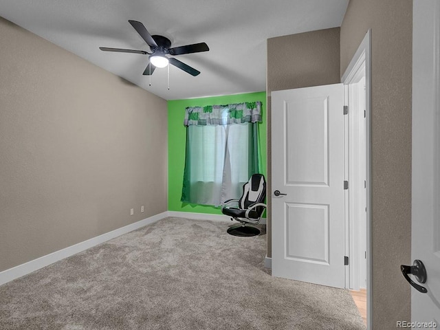 workout area with ceiling fan and light colored carpet