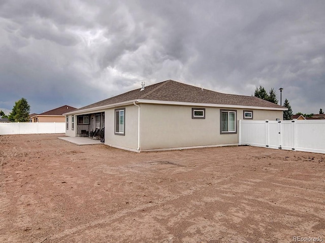 rear view of property featuring a patio area