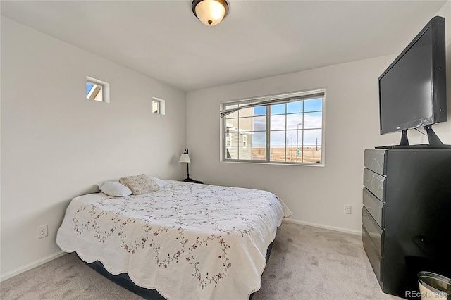 bedroom featuring light colored carpet