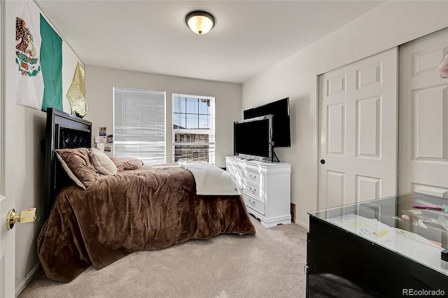 carpeted bedroom with a closet