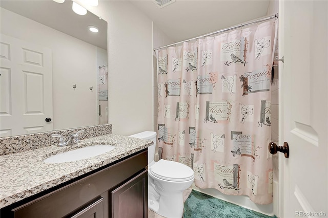 bathroom with toilet, vanity, and a shower with curtain