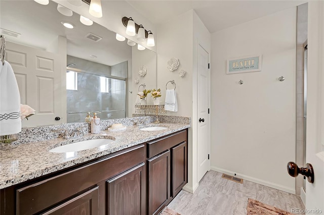 bathroom featuring walk in shower and vanity