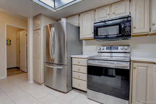 kitchen with appliances with stainless steel finishes and light tile patterned floors