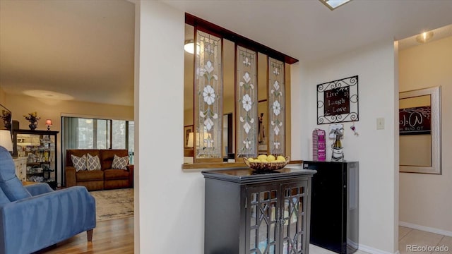 bar featuring light hardwood / wood-style floors