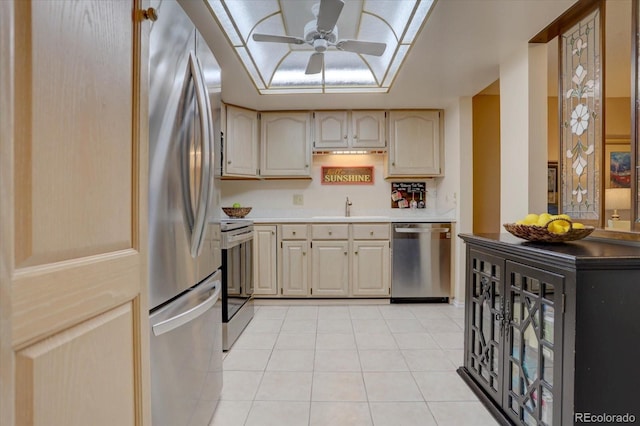 kitchen featuring a sink, stainless steel appliances, light tile patterned flooring, light countertops, and ceiling fan