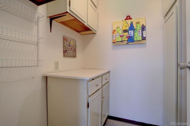 laundry room featuring baseboards