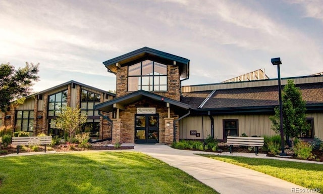 view of front of property with stone siding and a front yard