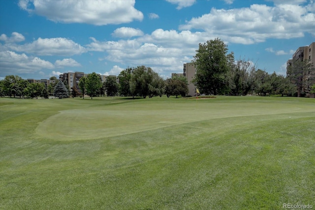 view of home's community featuring a lawn and view of golf course