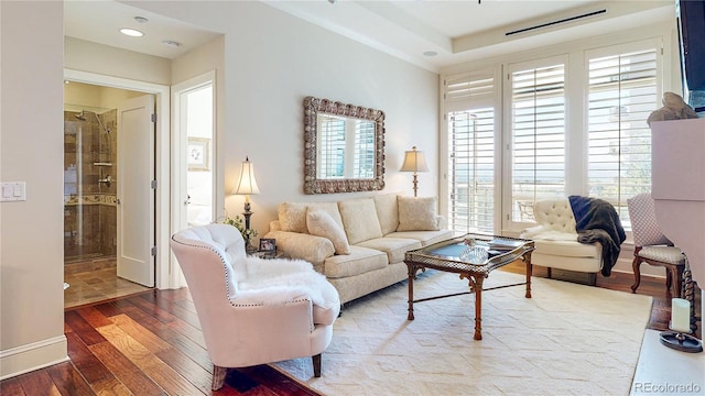 living room featuring hardwood / wood-style flooring and baseboards