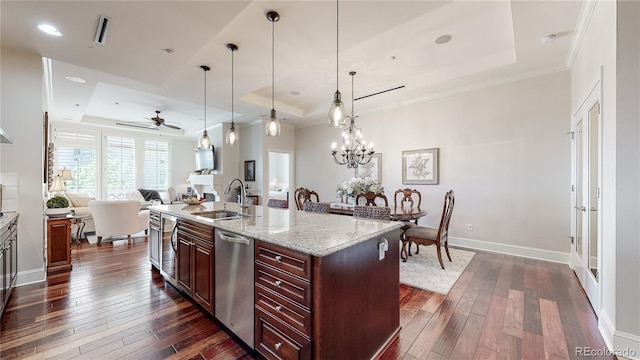 kitchen with a sink, a raised ceiling, open floor plan, and dark wood-style flooring