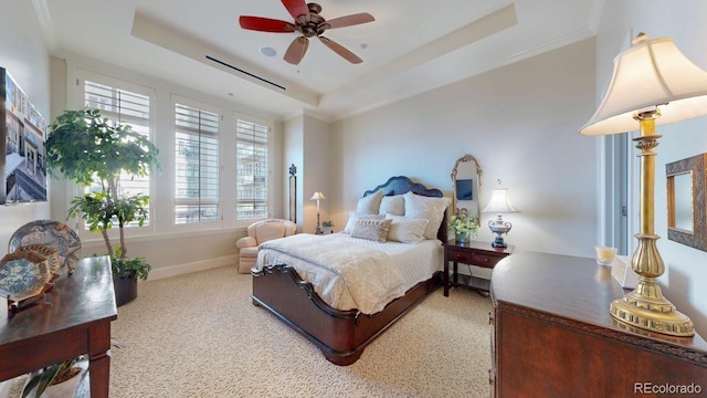 carpeted bedroom with a ceiling fan, a raised ceiling, crown molding, and baseboards