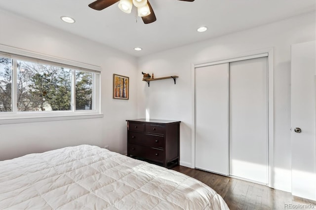 bedroom with a closet, recessed lighting, dark wood-type flooring, and ceiling fan