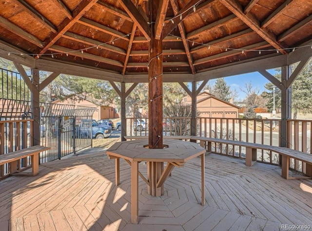 wooden terrace with a gazebo and fence