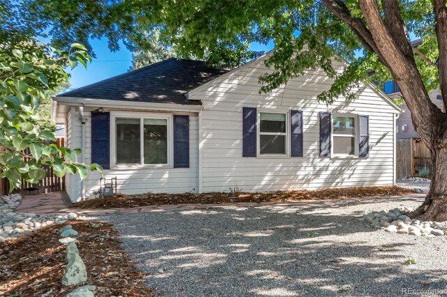 1160 S Monroe St, Denver, CO 80210 - view of front facade with roof with shingles and fence