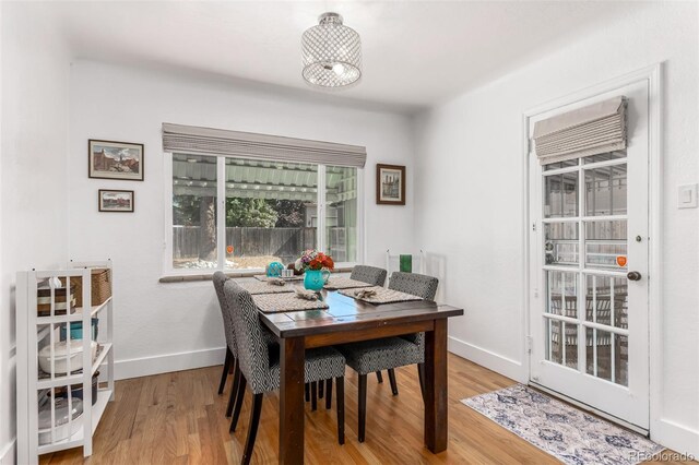 1160 S Monroe St, Denver, CO 80210 - dining space featuring light wood-style flooring and baseboards