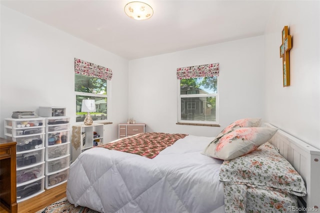 bedroom featuring hardwood / wood-style floors and multiple windows