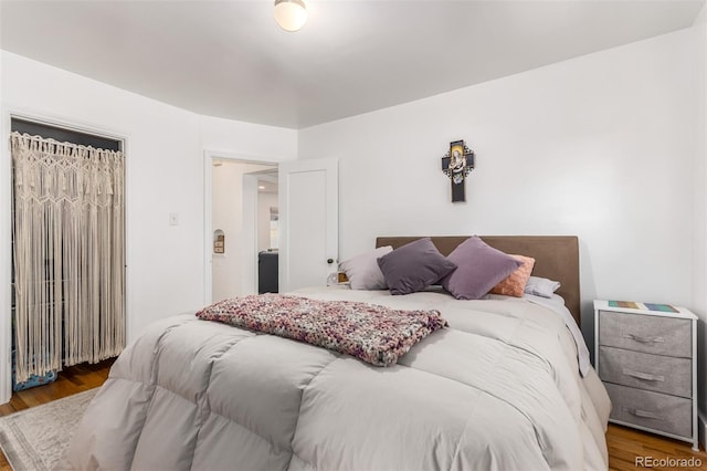 bedroom with dark wood-type flooring