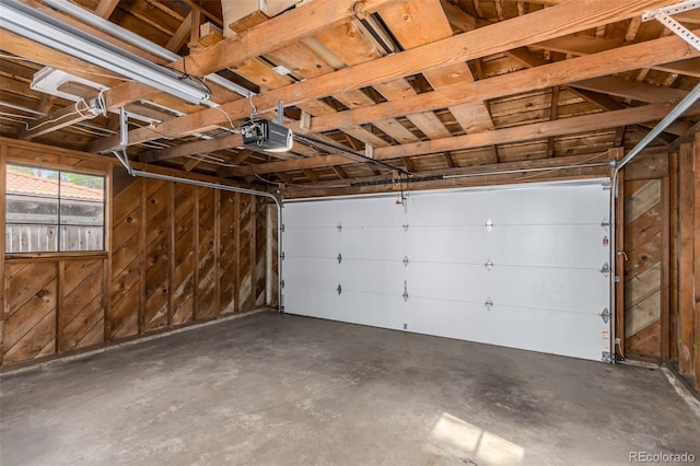 1160 S Monroe St, Denver, CO 80210 - garage with wood walls and a garage door opener