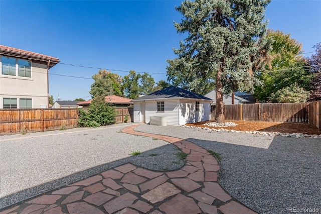 1160 S Monroe St, Denver, CO 80210 - view of front of home featuring a patio, an outbuilding, and a fenced backyard