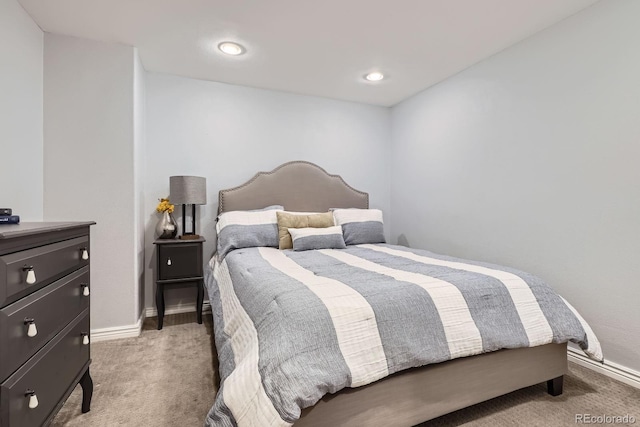 bedroom with baseboards, recessed lighting, and light carpet
