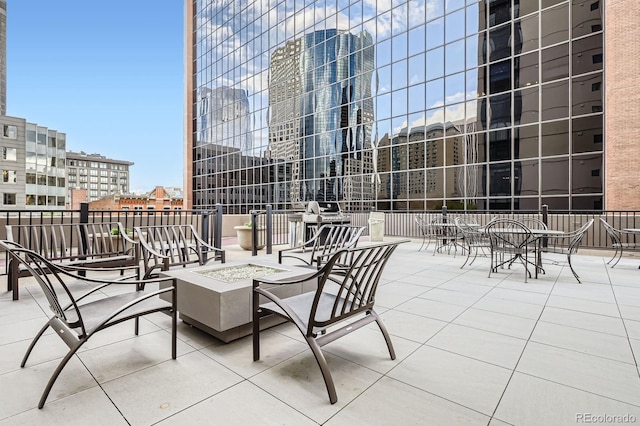 view of patio featuring a city view and a fire pit