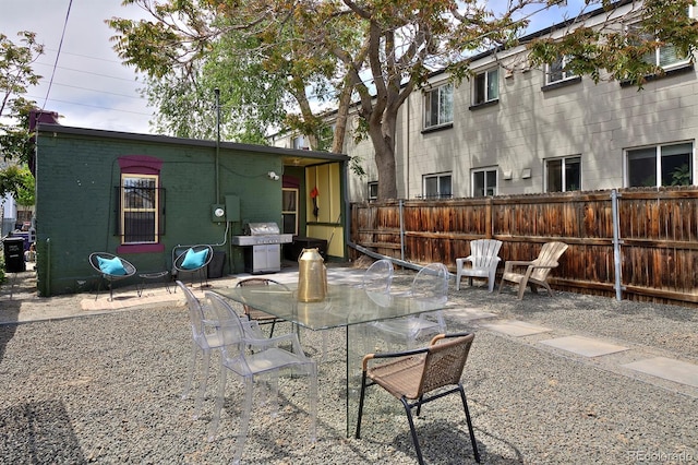 view of patio featuring fence and outdoor dining area