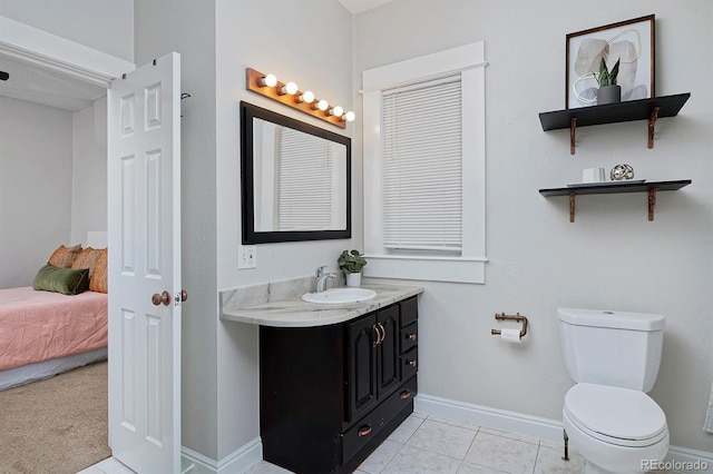 2424 N Clay St, Denver, CO 80211 - bathroom featuring vanity, toilet, tile patterned flooring, and baseboards