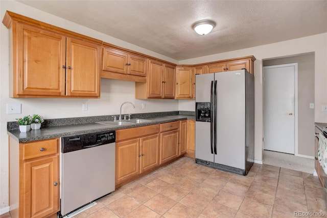 kitchen with sink and appliances with stainless steel finishes