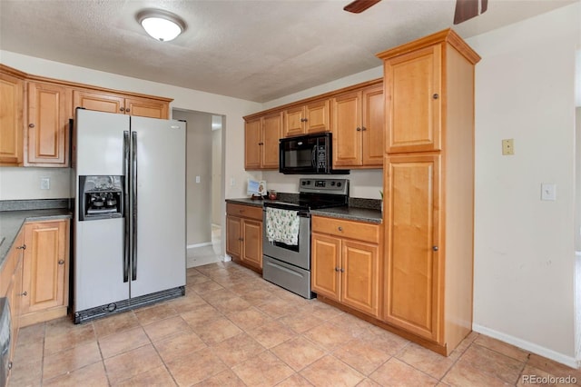 kitchen with ceiling fan, appliances with stainless steel finishes, and a textured ceiling