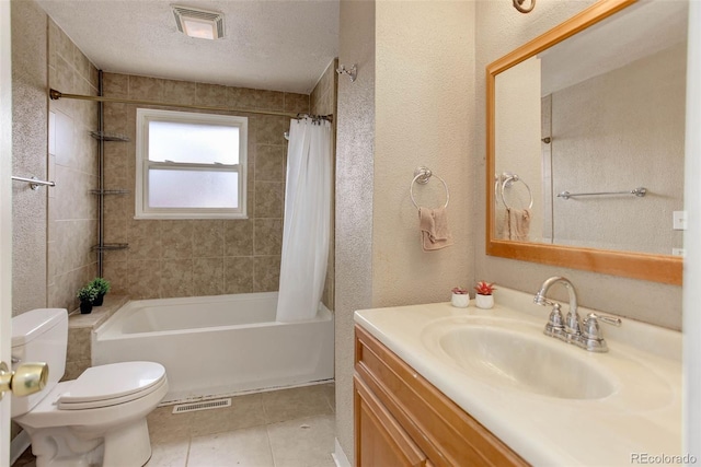 full bathroom with shower / tub combo, vanity, a textured ceiling, tile patterned floors, and toilet