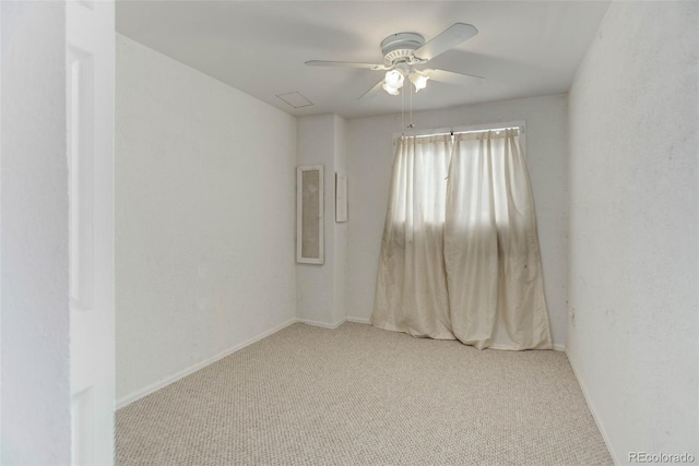 spare room with light colored carpet and ceiling fan