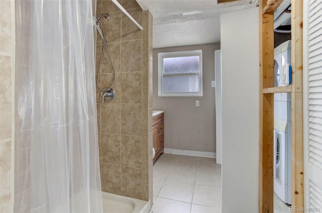 bathroom featuring walk in shower, a textured ceiling, vanity, washer / clothes dryer, and tile patterned flooring