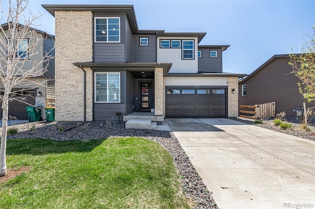 view of front of home featuring fence, a front yard, stone siding, concrete driveway, and an attached garage