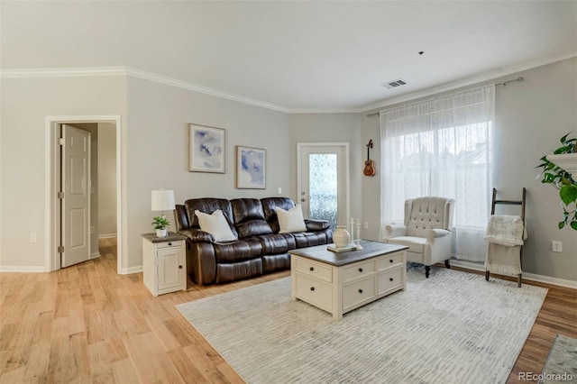 living area featuring light wood-type flooring, visible vents, ornamental molding, and baseboards