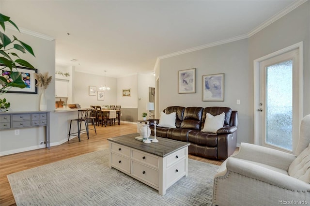 living area with light wood finished floors, ornamental molding, and plenty of natural light