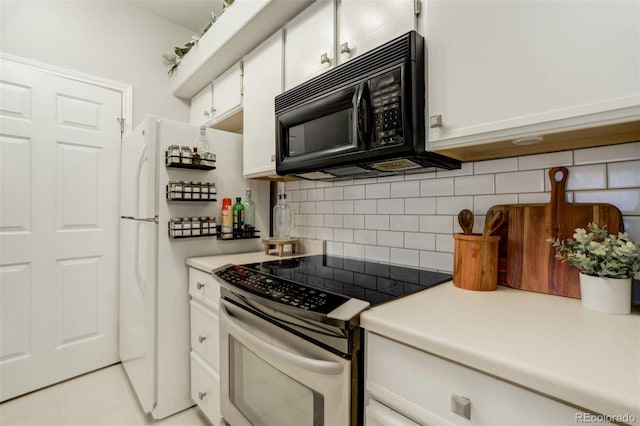 kitchen featuring electric stove, black microwave, white cabinets, and tasteful backsplash