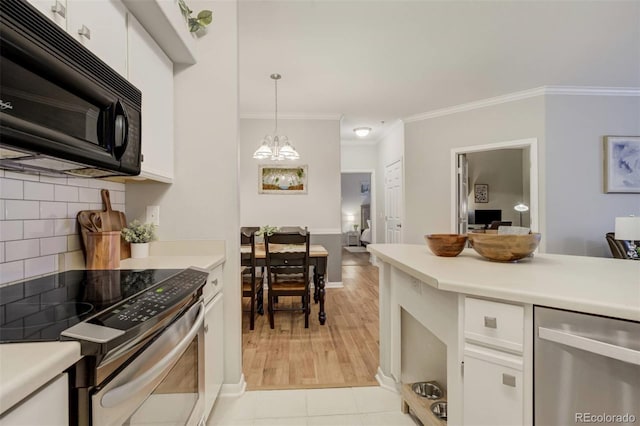 kitchen with light countertops, backsplash, stainless steel range with electric cooktop, white cabinets, and black microwave