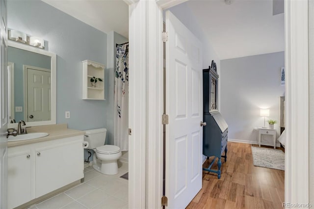 bathroom with vanity, toilet, and wood finished floors