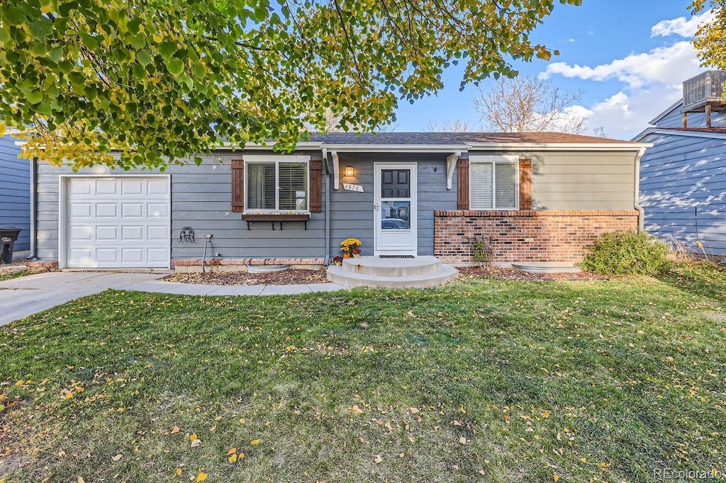 ranch-style house with a garage and a front yard