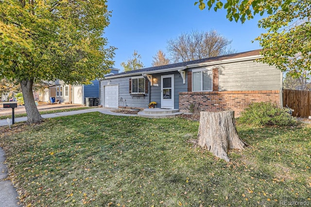 ranch-style house with a garage and a front yard