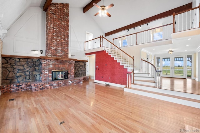 6231 Prospect Rd, Longmont, CO 80503 - unfurnished living room with high vaulted ceiling, wood-type flooring, a ceiling fan, stairs, and beam ceiling