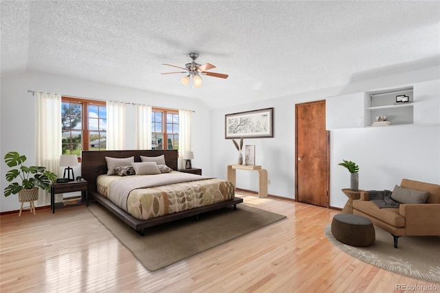 6231 Prospect Rd, Longmont, CO 80503 - bedroom with a textured ceiling, light wood finished floors, vaulted ceiling, baseboards, and ceiling fan